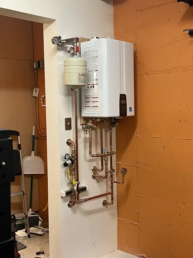 Plumbing technician inspecting water heater connections in Madeira Beach